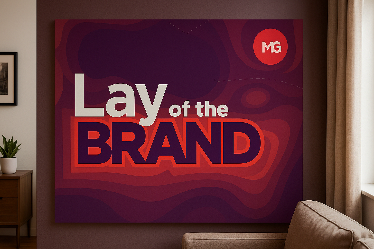 The Lay of the Brand logo is displayed as a large canvas on a beige wall, located inside a simple home office setting. The canvas is dominates the bulk of the image.